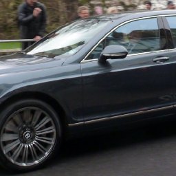 Kate waving from the car